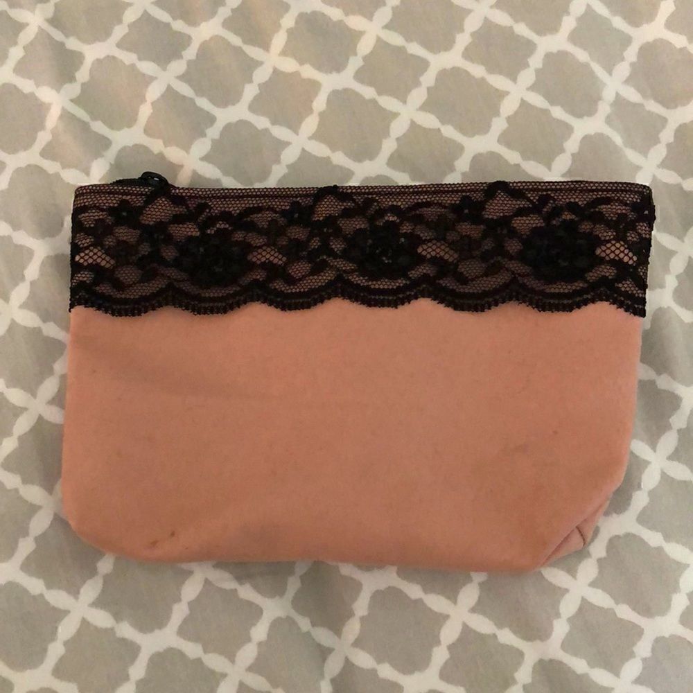IPSY pink cosmetics bag with black lace trim, includes 5 trial products